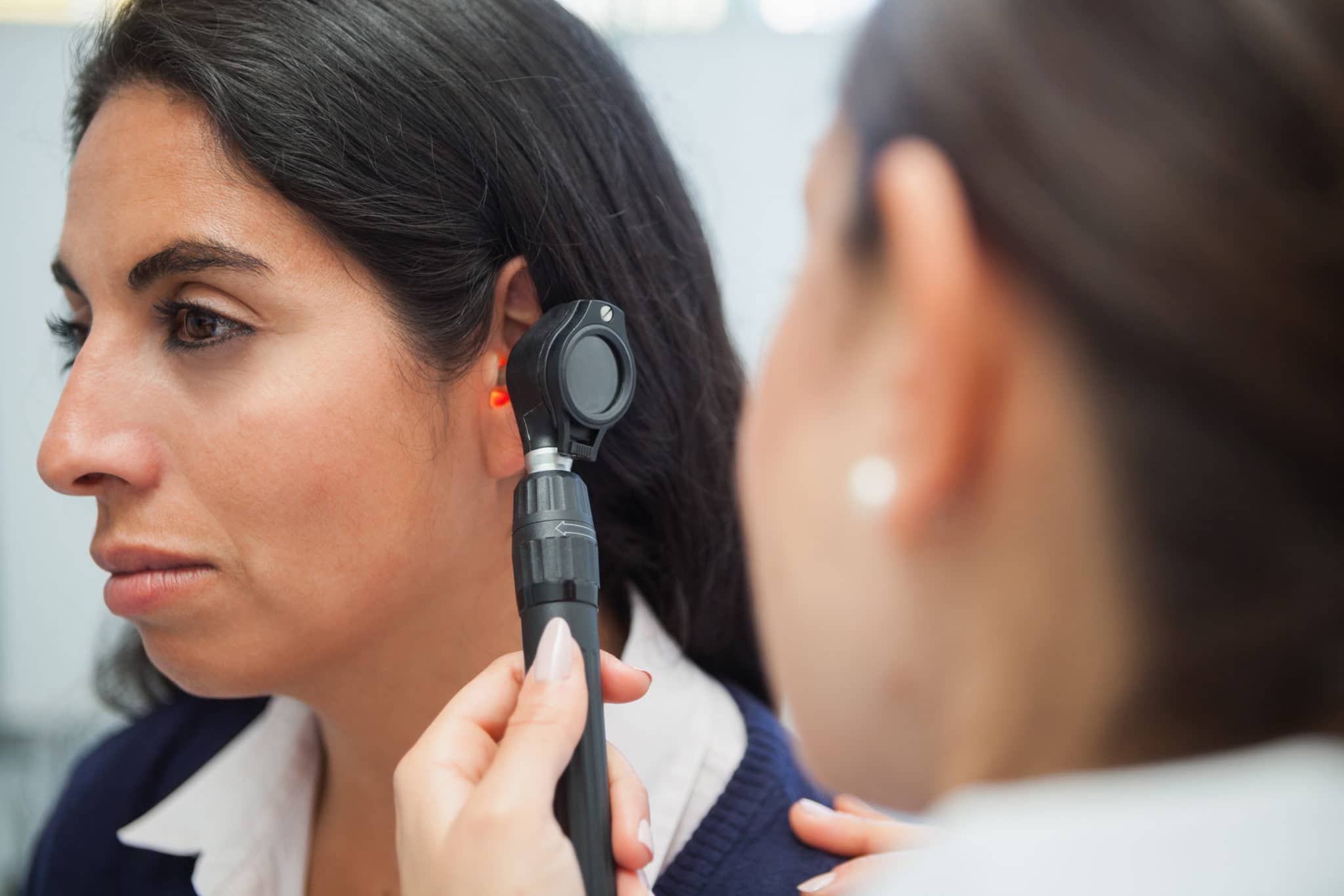 Otolaryngologist checking a patient's ear