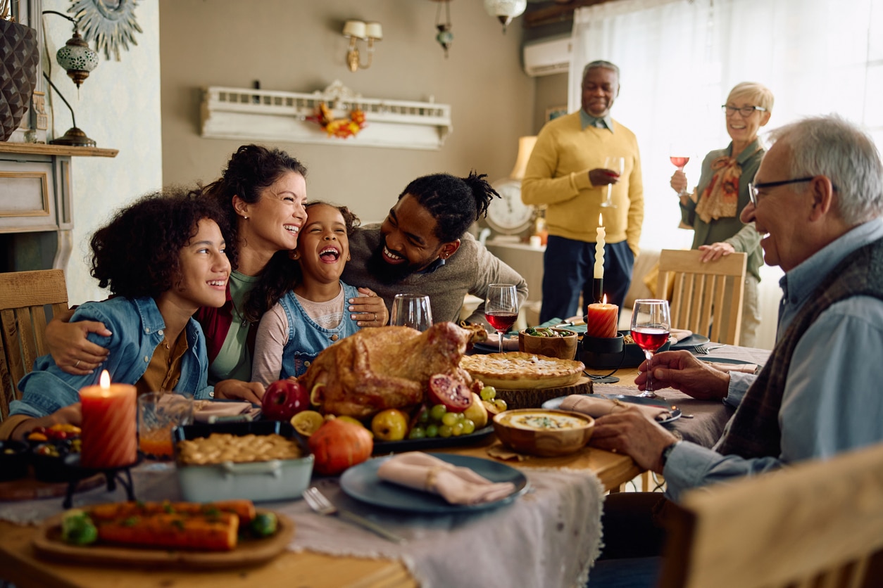 Happy family sitting down for Thanksgiving dinner