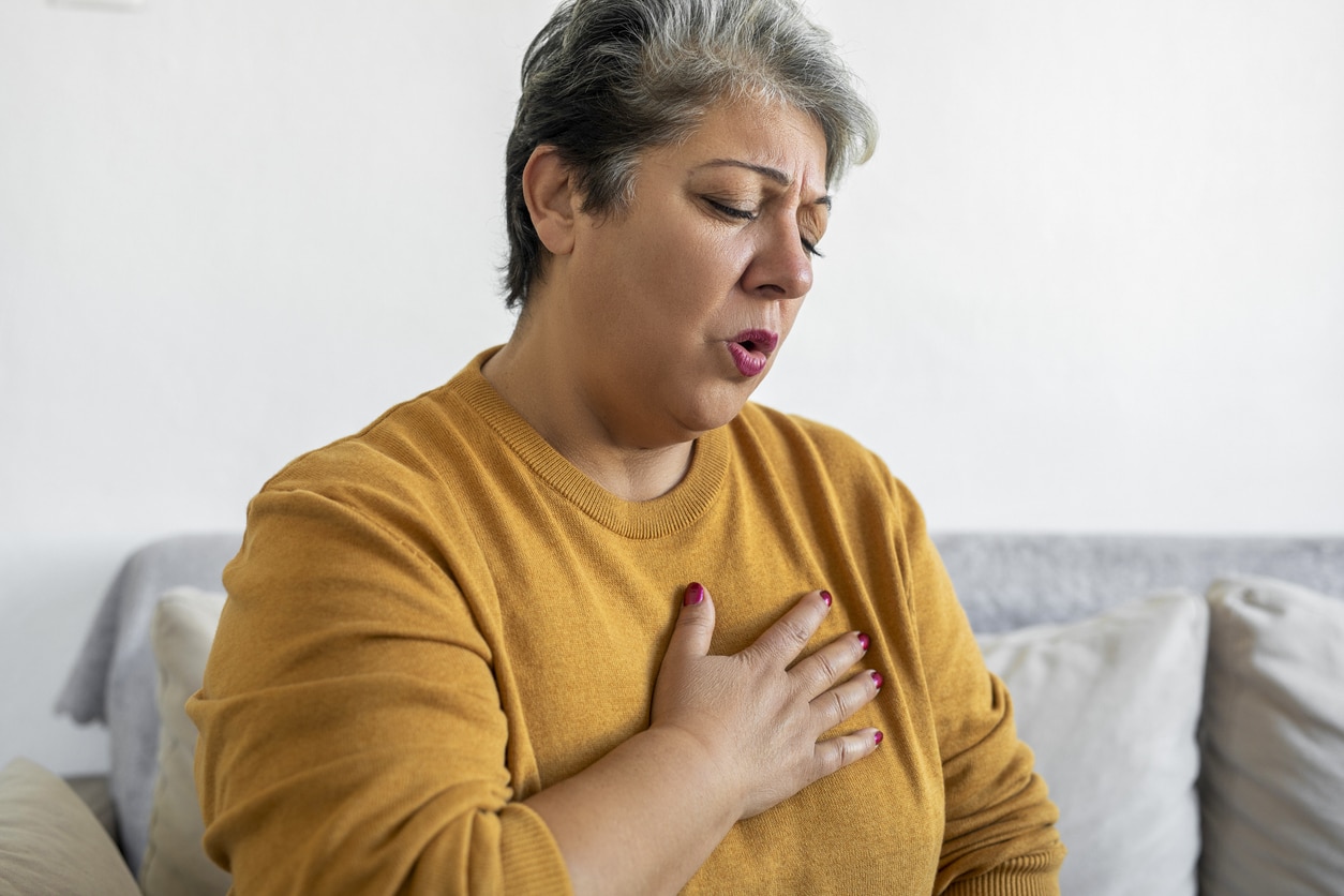 Woman with acid reflux holding her chest