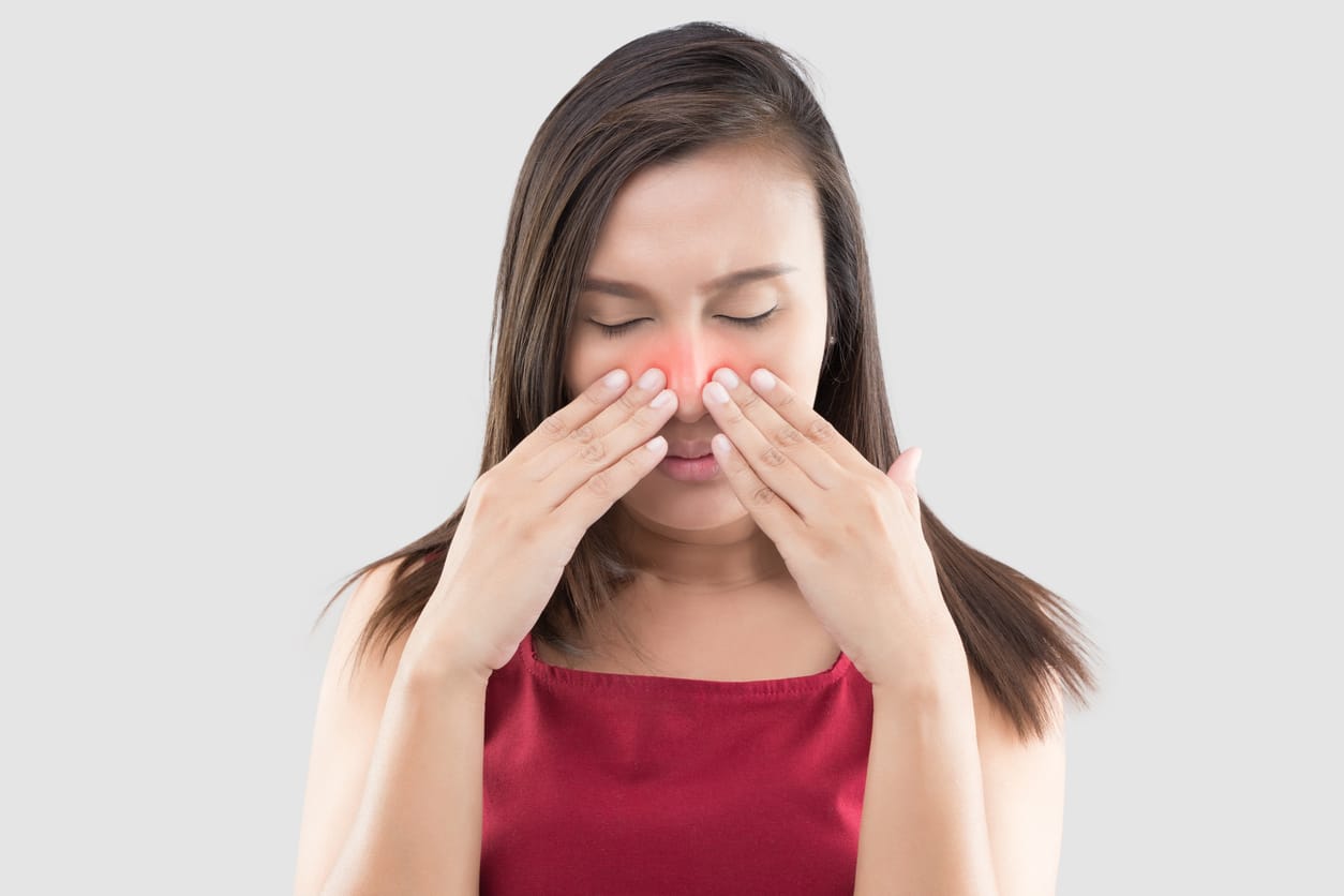 Woman touching her red sinuses
